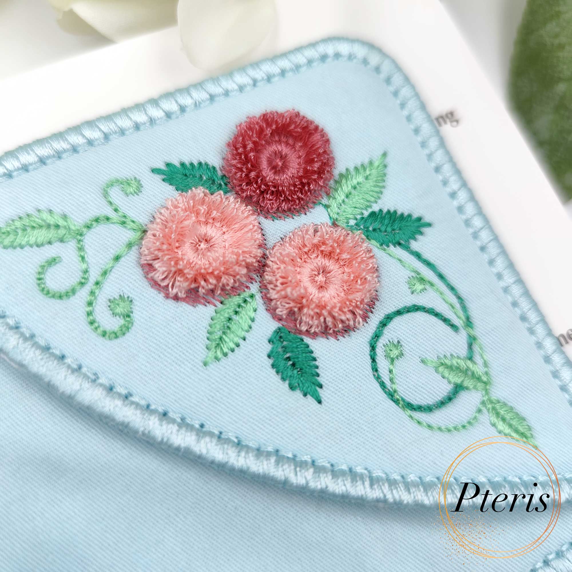 ITH Corner Bookmark embroidery design with 3D pink chenille and fringe roses on light blue fabric