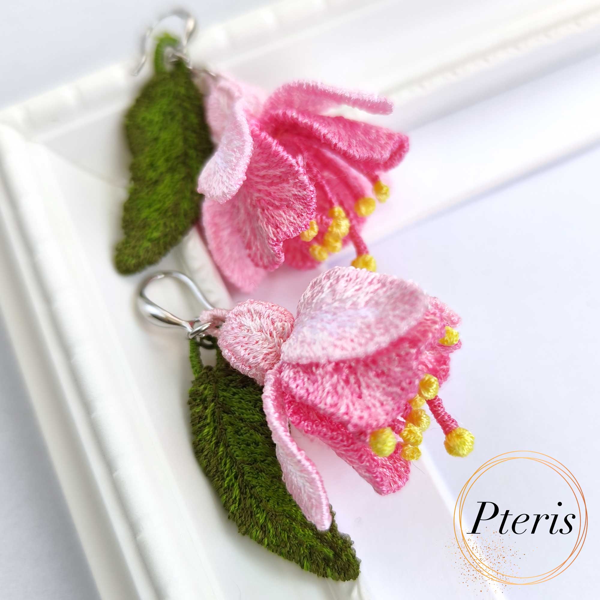 FSL 3D Fuchsia flower earrings machine embroidery design featuring pink petals and green leaves on silver hooks.