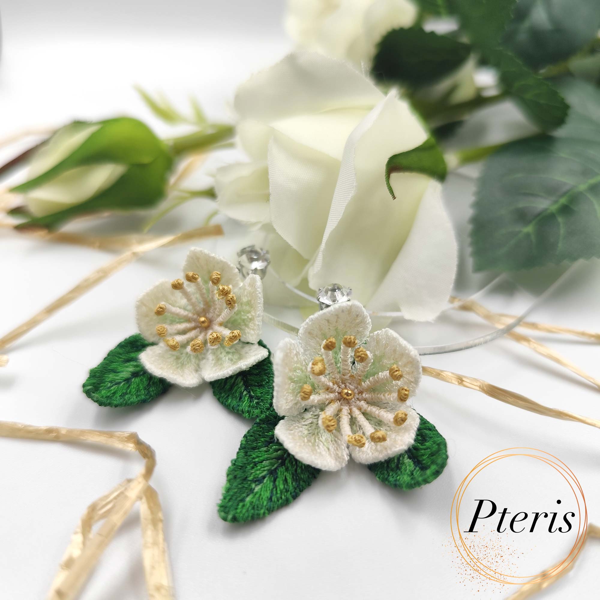 3D Jasmine Embroidery Design for FSL jewelry featuring delicate white petals with yellow centers and green leaves.
