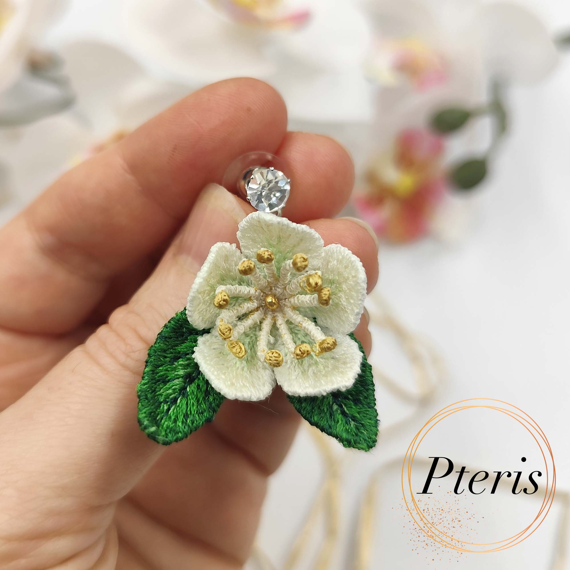 3D Jasmine Embroidery Design for FSL jewelry featuring delicate white petals with yellow centers and green leaves.
