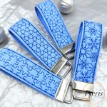 ITH Snowflake and Geometric Wrist Strap Key Fob embroidery design on blue and pink faux leather
