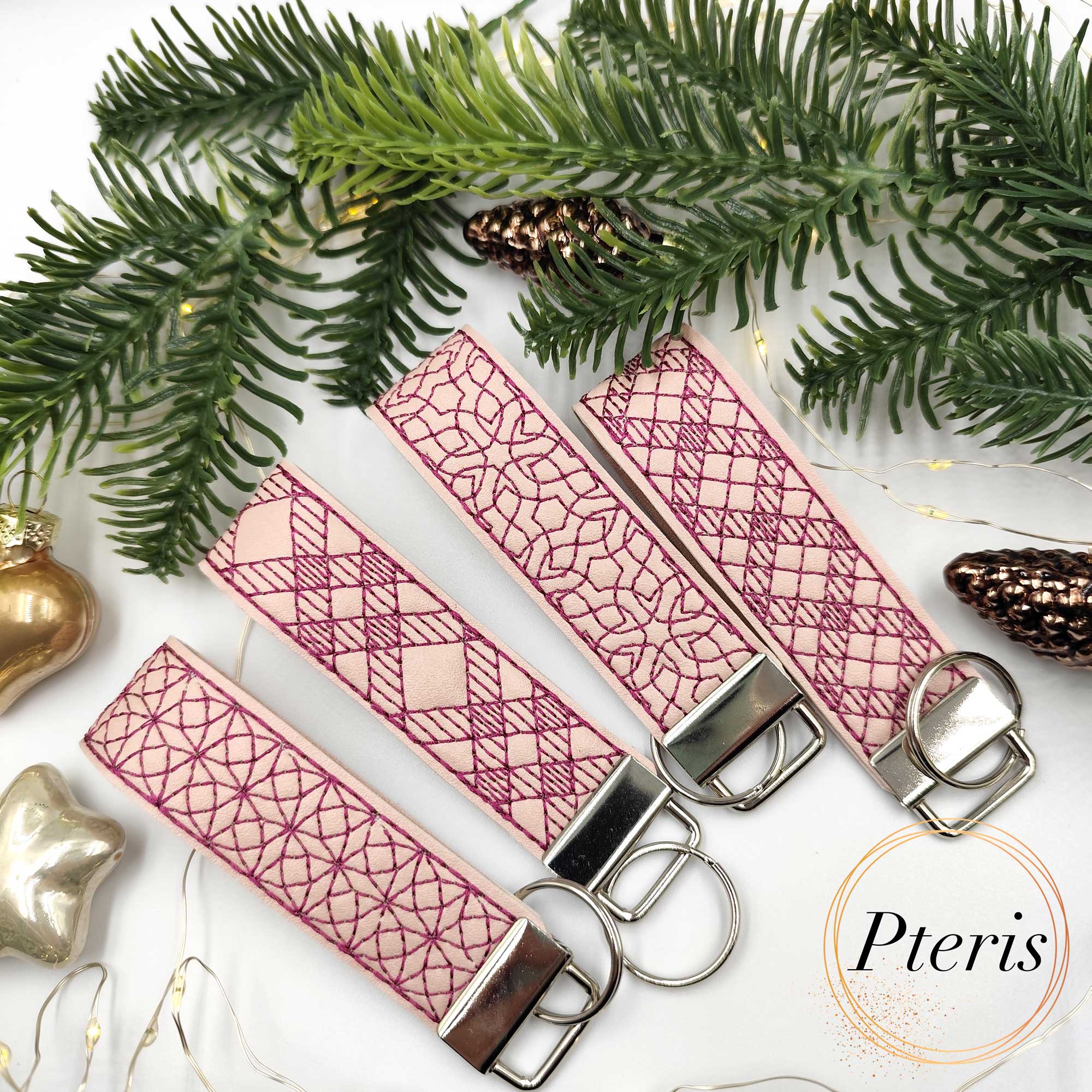 ITH Geometric Wrist Strap Key Fob embroidery design on pink faux leather with burgundy stitching