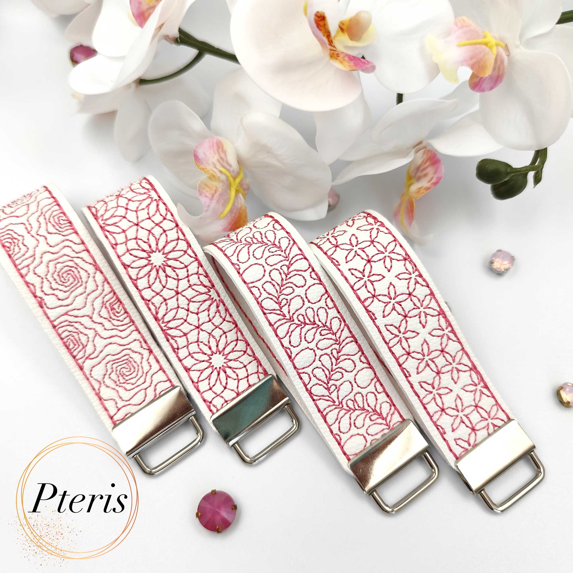 ITH Quilted Floral Key Fob embroidery design on white faux leather with pink stitching