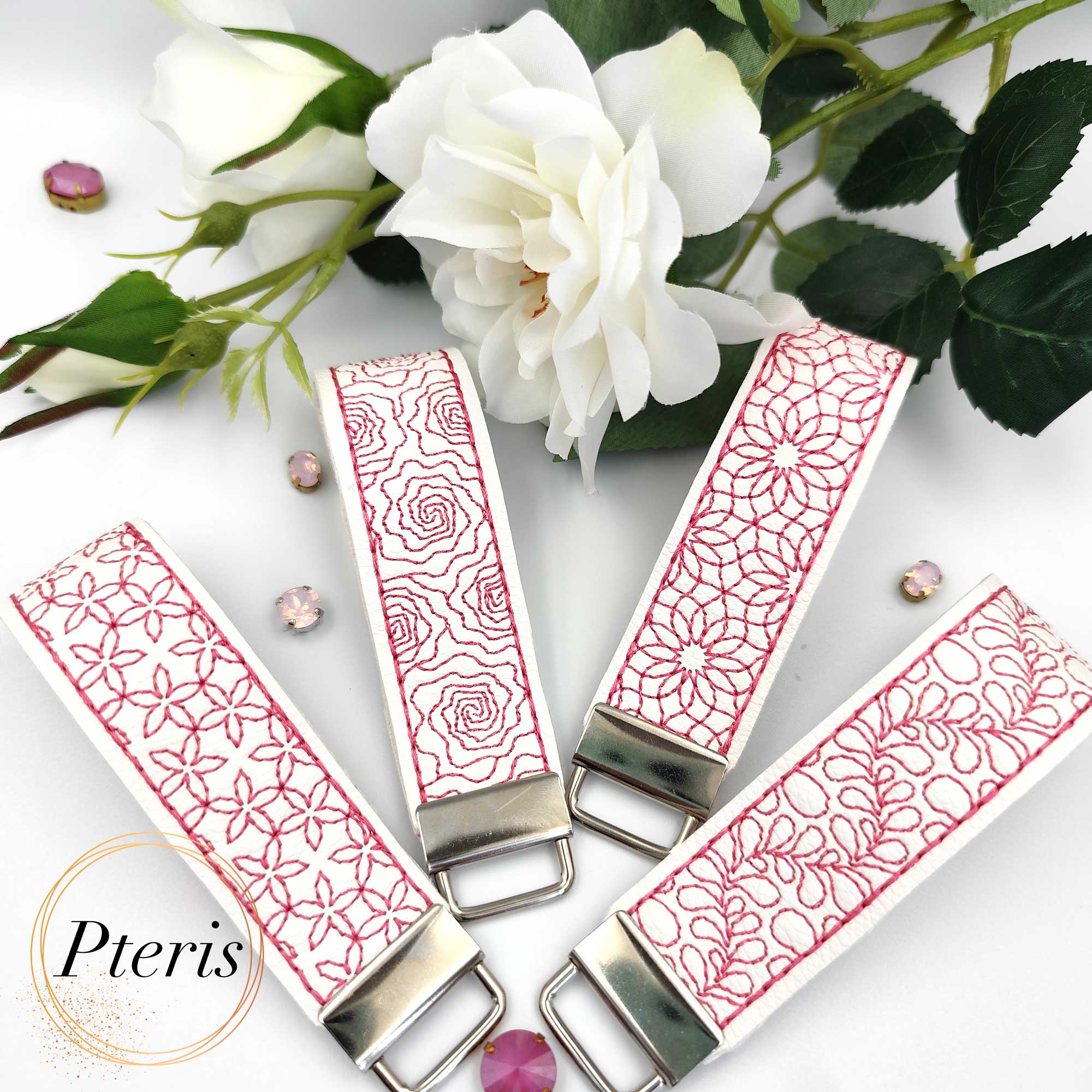 ITH Quilted Floral Key Fob embroidery design on white faux leather with pink stitching