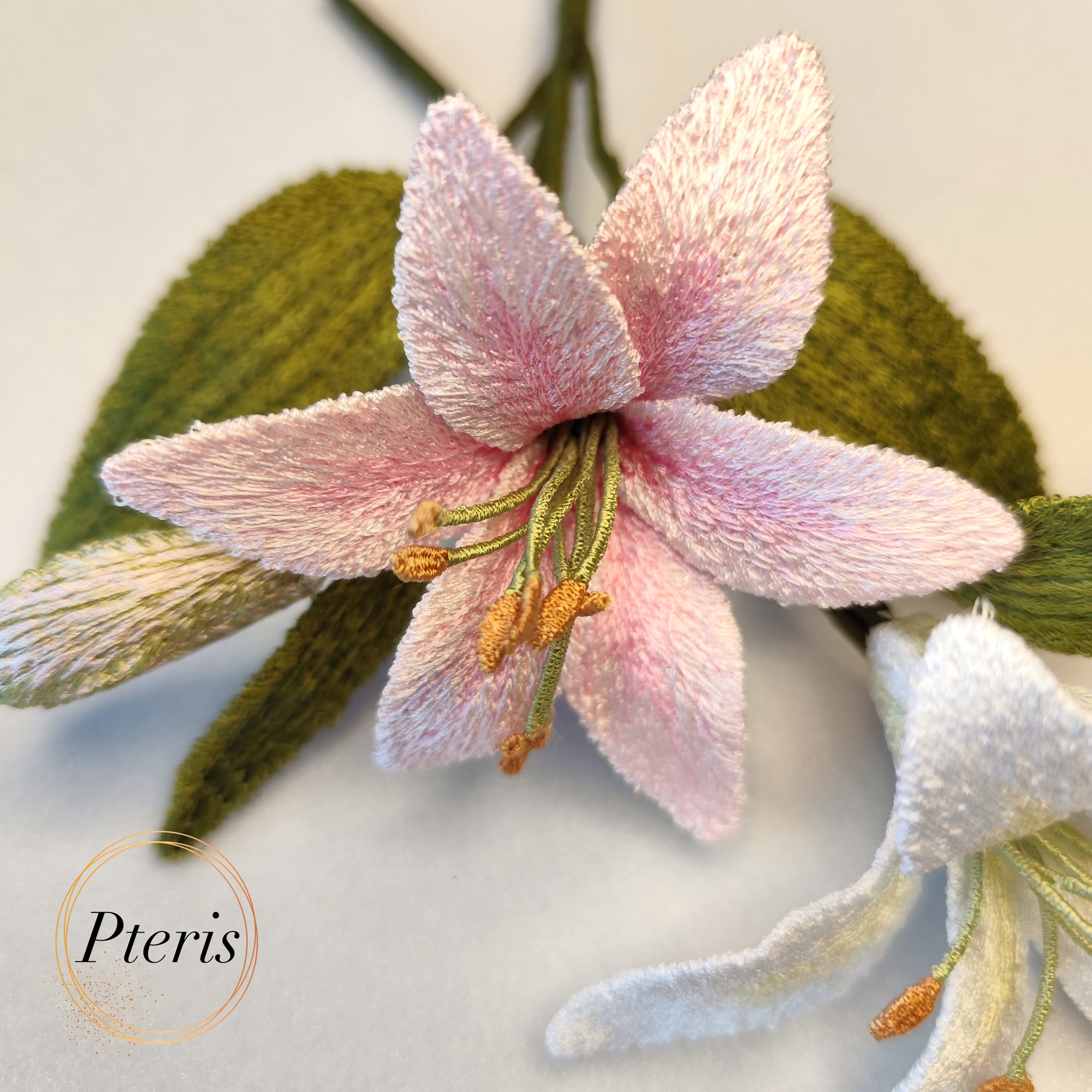 3D Lily Embroidery Design for FSL interior decor featuring white and pink blooming lilies with green leaves and a detailed bud.