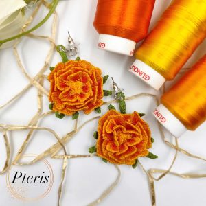 3D Marigold Embroidery Design for FSL jewelry featuring bright orange ruffled petals and green textured leaves on silver earring studs.