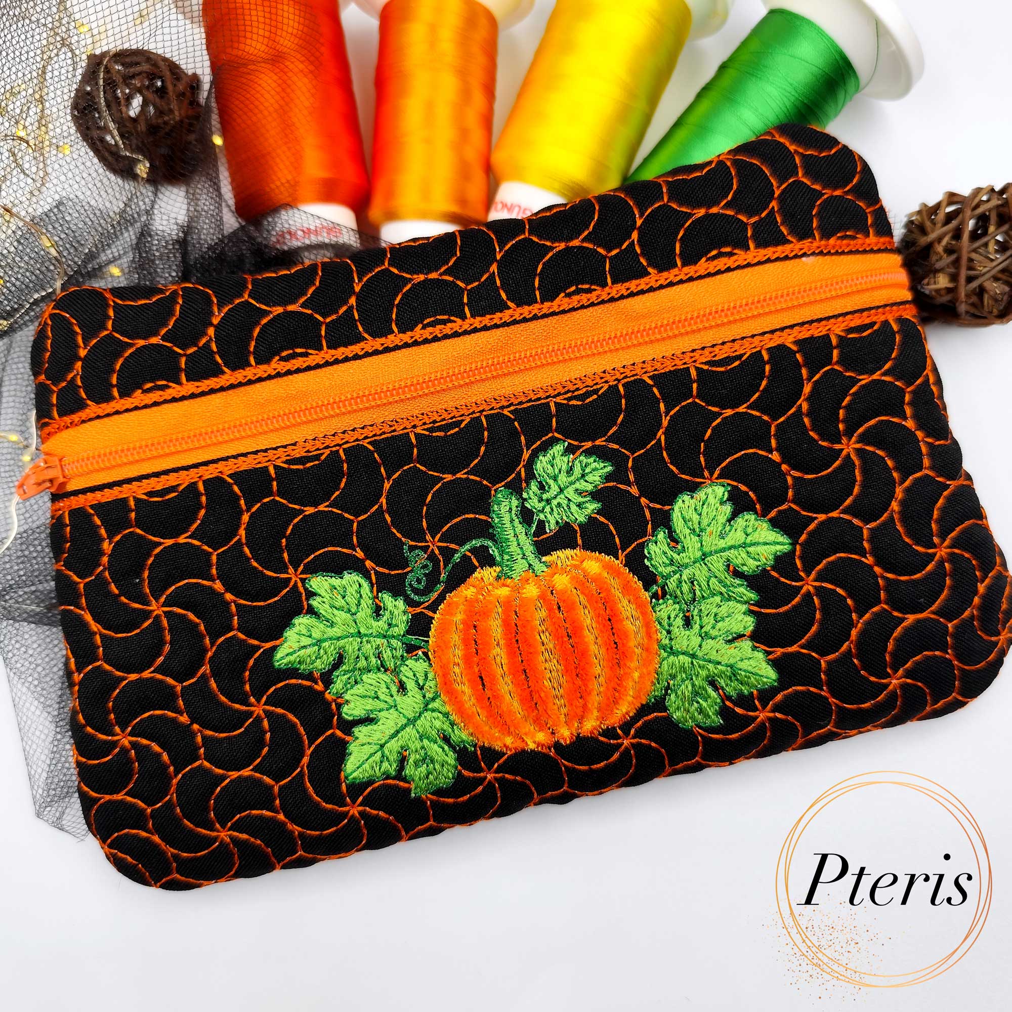 Add a festive touch to your autumn décor with our Fringed Pumpkin Zipper Pouch ITH design. The standout feature of this bag is the central pumpkin motif, created using a specialized fringe technique that gives the pumpkin a soft, 3D textured appearance. Complemented by vibrant green leaves and a unique swirling quilt pattern that mimics vines, this pouch is a masterpiece of seasonal embroidery.
