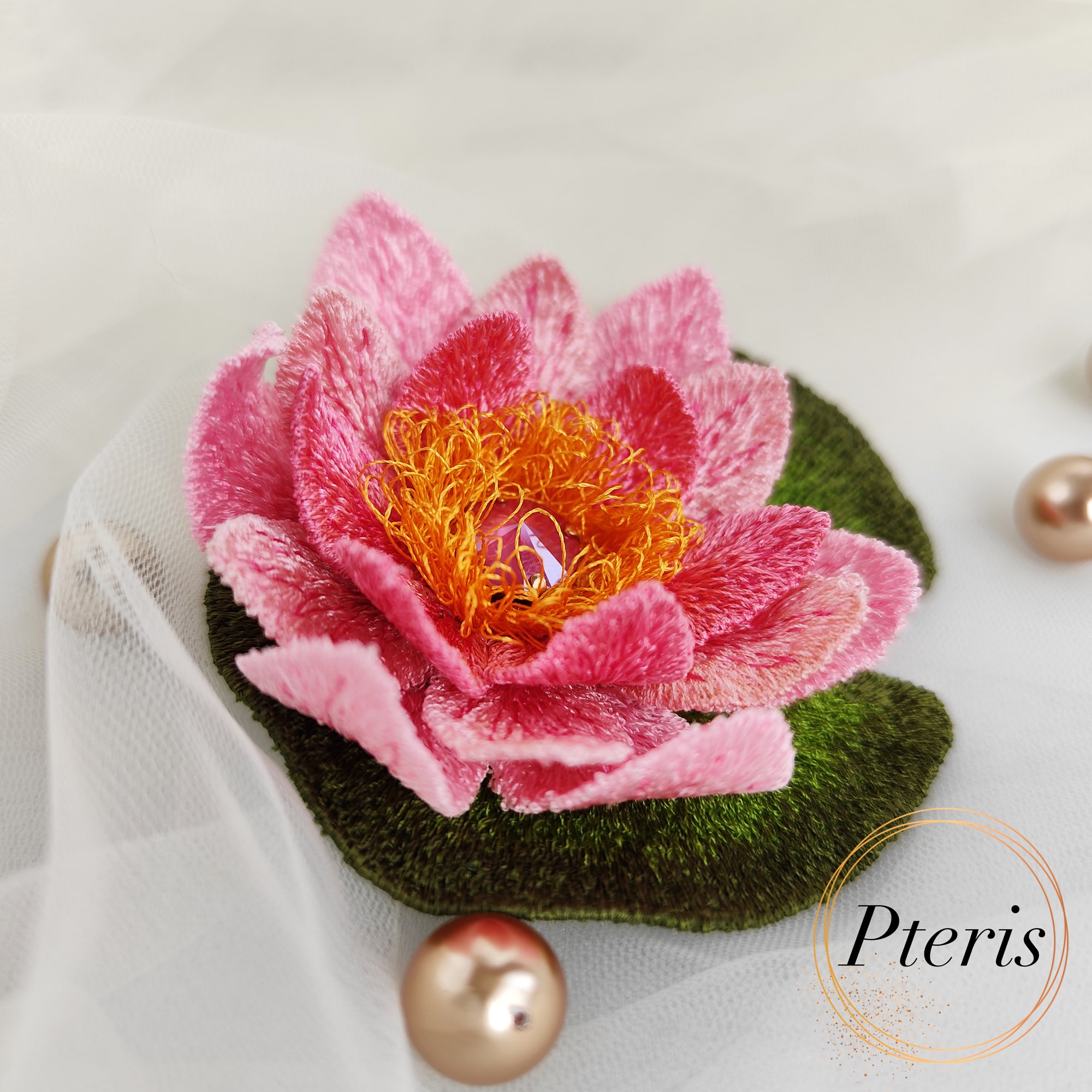 FSL 3D Water Lily brooch machine embroidery design with pink gradient petals, yellow stamens, and a green leaf pad.