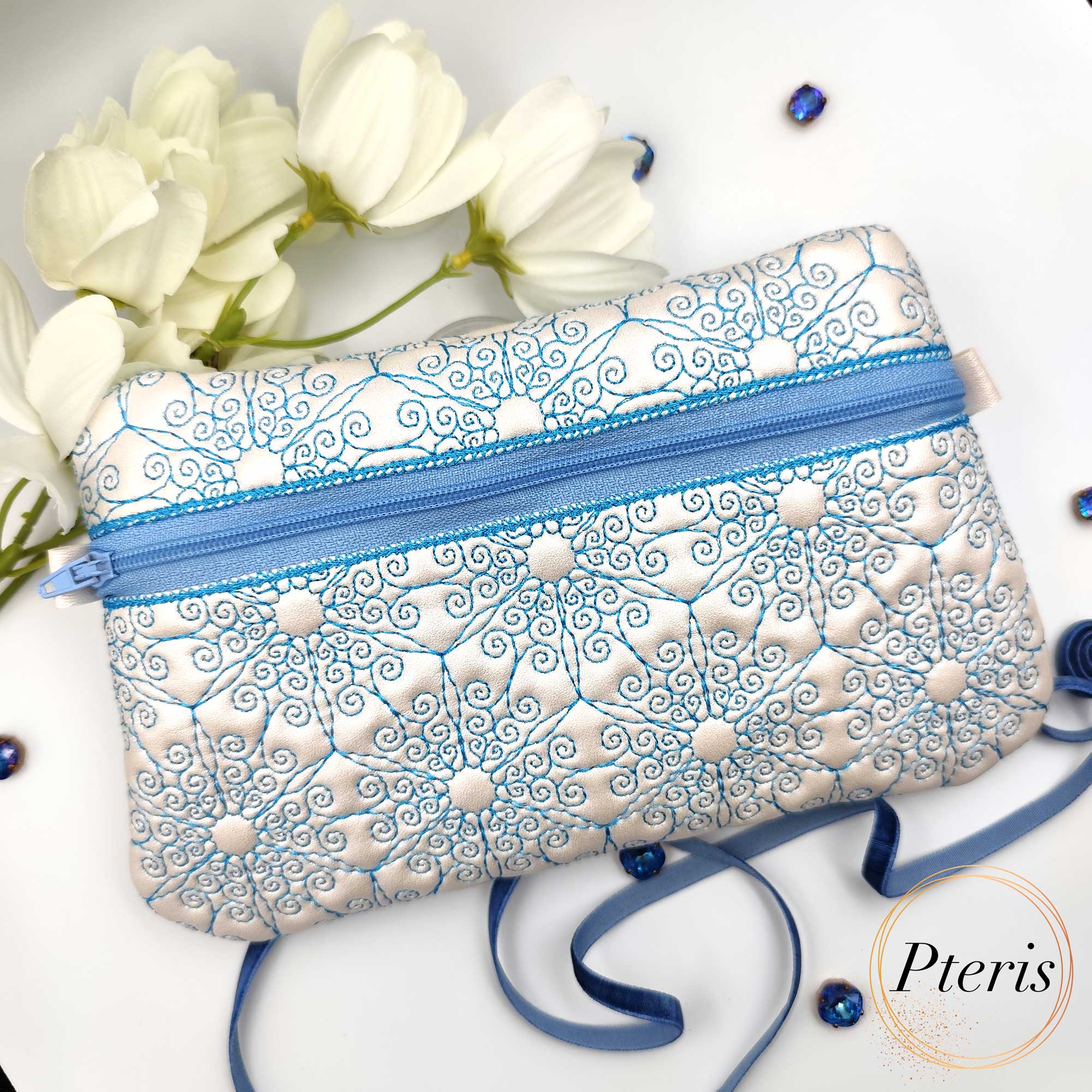 ITH Ornamental Zipper Pouch embroidery design with blue scroll pattern on pearl leather