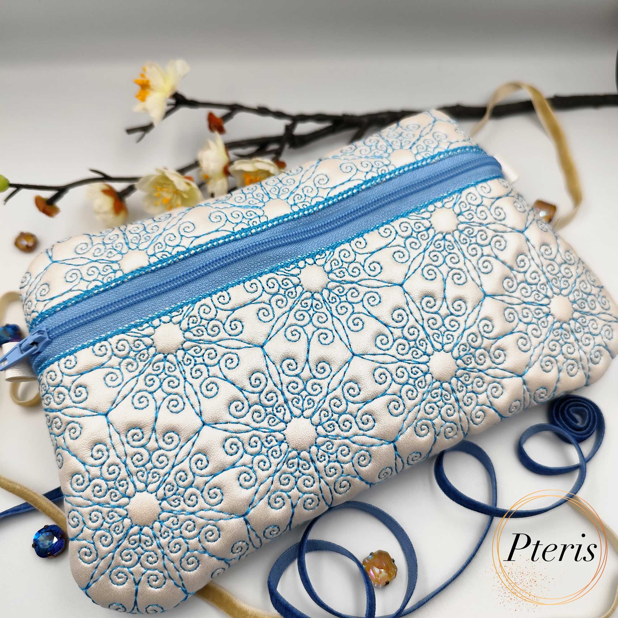 ITH Ornamental Zipper Pouch embroidery design with blue scroll pattern on pearl leather
