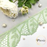 FSL Filet Lace Border Design showing a light green freestanding lace trim with a geometric crochet-style pattern, styled with white flowers and pearls.