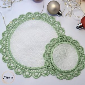 FSL Crochet Style Napkin Design featuring two light green lace coasters with white fabric centers, styled with Christmas ornaments and fairy lights.
