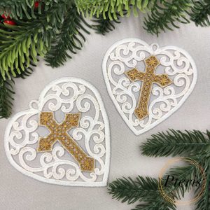 FSL Heart with Cross Suncatcher embroidery design featuring two white freestanding lace hearts with intricate gold crosses, styled with evergreen branches and red berries.