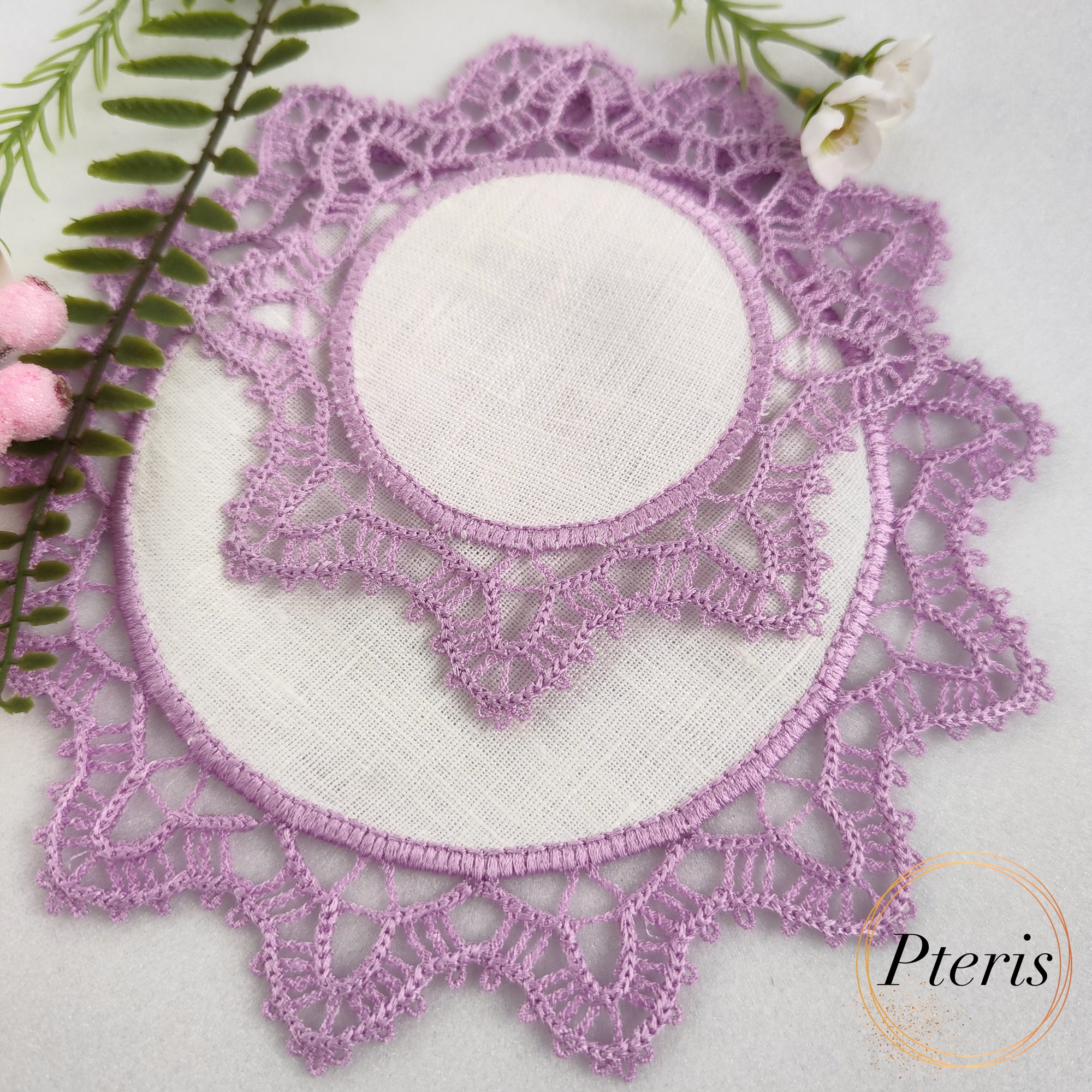 FSL Crochet Style Coaster Design featuring two lavender-colored lace napkins with white fabric centers, styled with pink berries and white flowers.