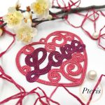 FSL Love Heart Suncatcher embroidery design featuring a pink and purple freestanding lace heart with "Love" script, styled with white spring blossoms and pearls.