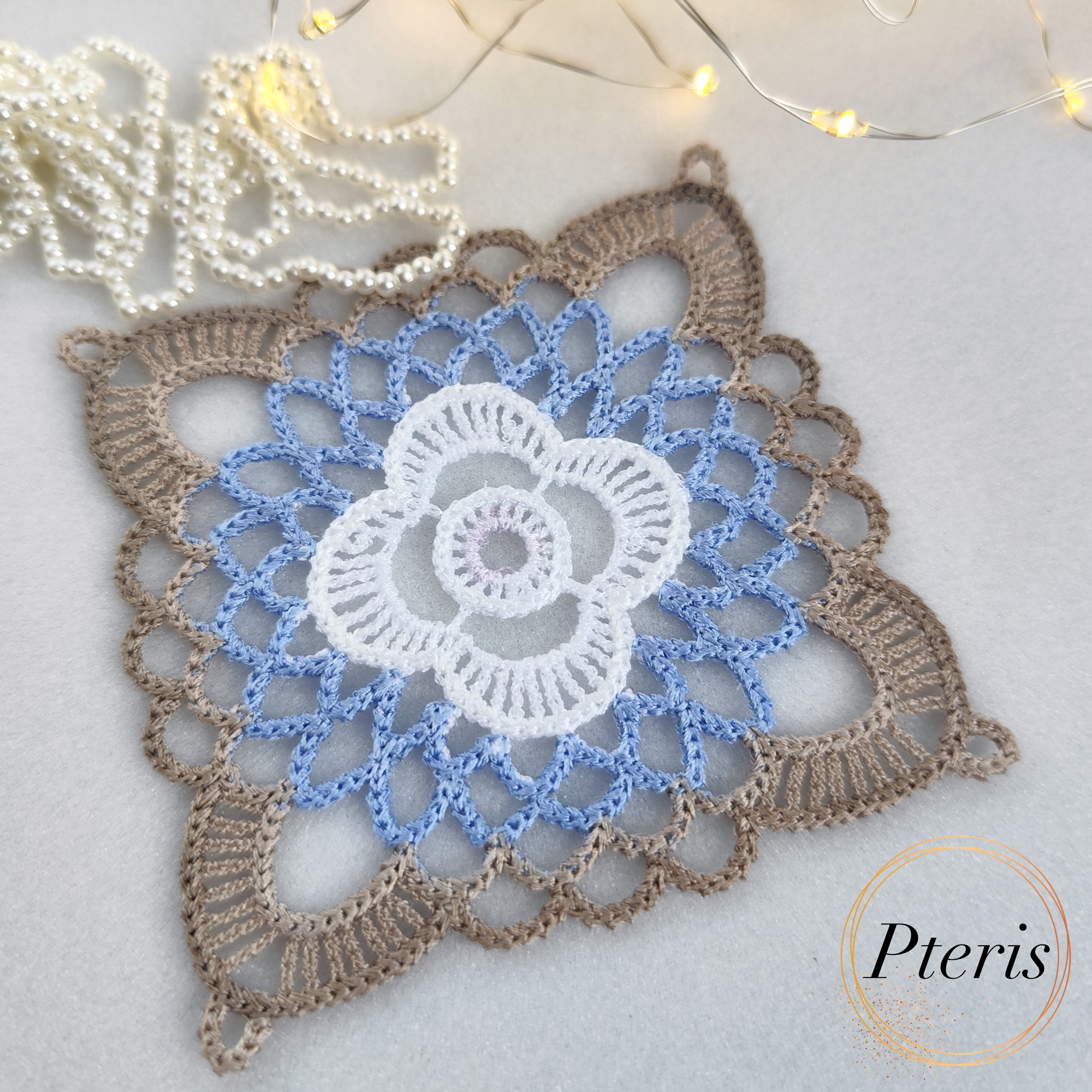 FSL Granny Square Crochet Design featuring freestanding lace coasters with a white central flower, light blue inner petals, and a beige scalloped border.