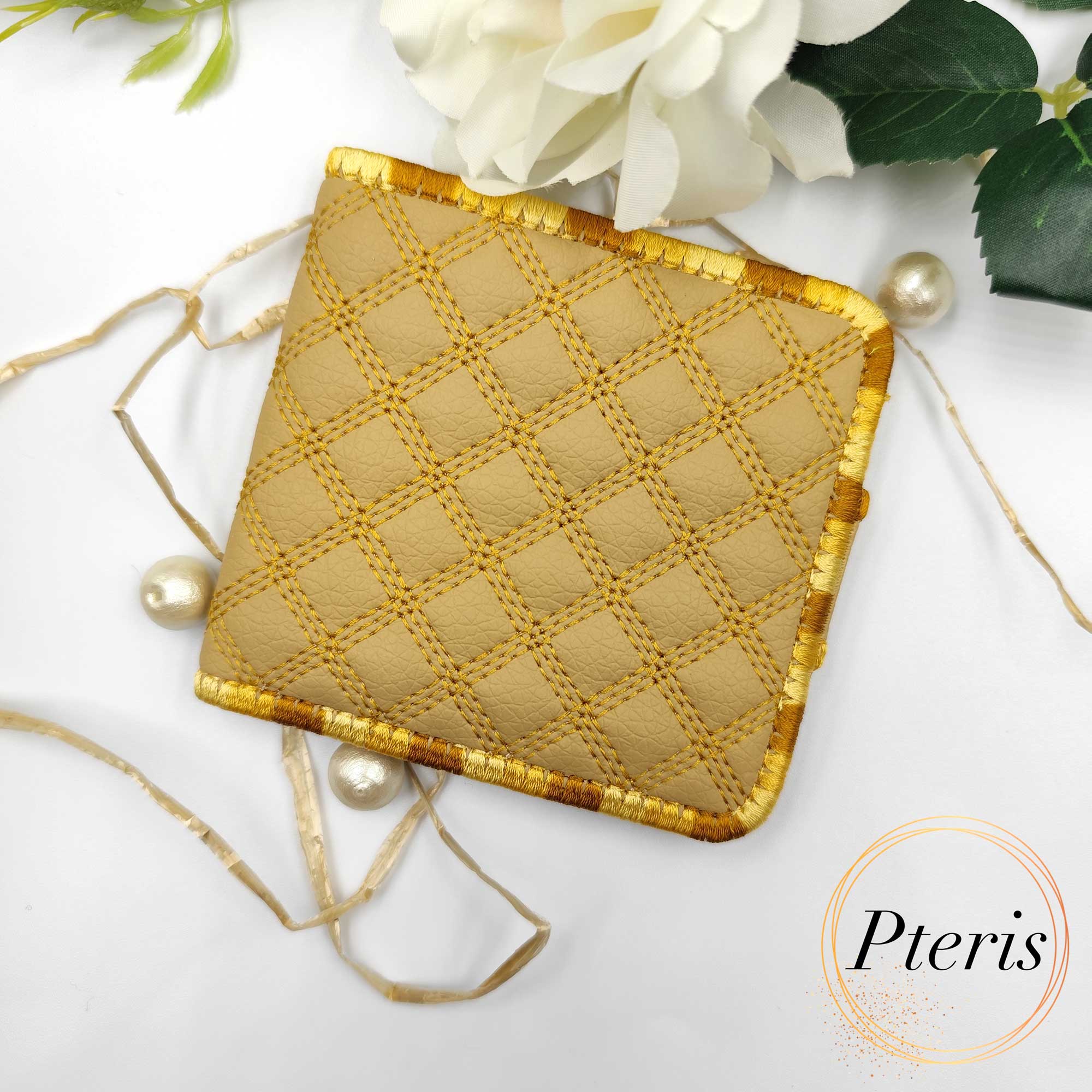 ITH Quilted Wallet embroidery design showing a handmade bifold wallet with blue diamond quilting, credit card slots, and a bill compartment, styled with a blue thread spool.