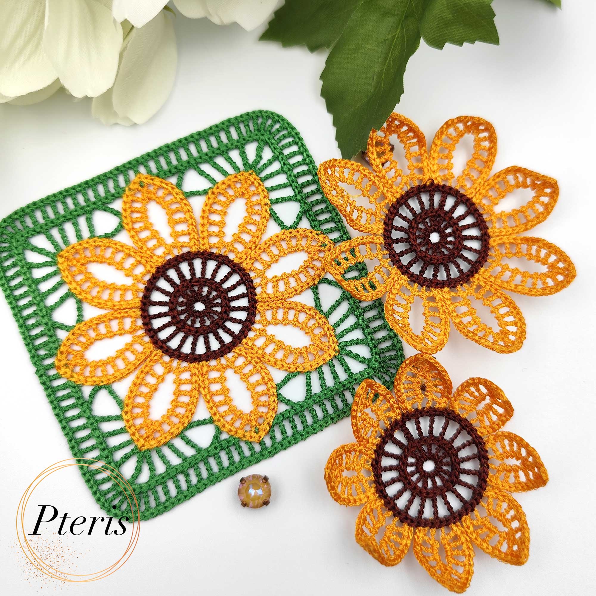 FSL 3D Sunflower Embroidery Design showing a bright orange and brown textured sunflower attached to a green lace granny square in a crochet-style finish.