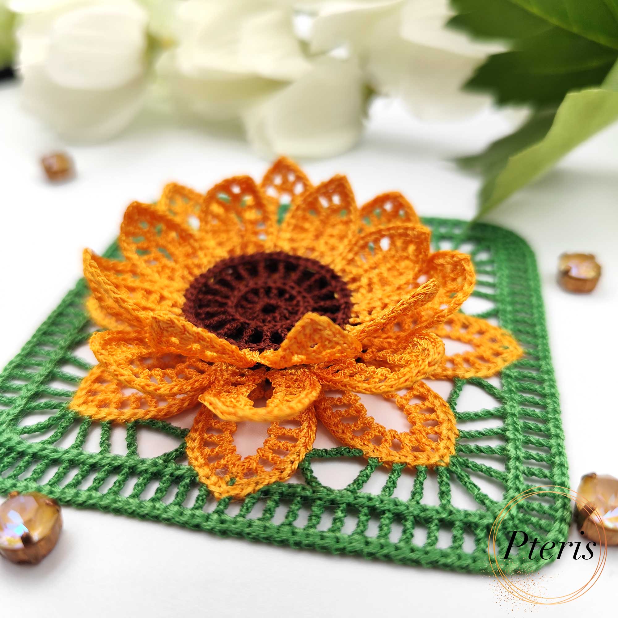 FSL 3D Sunflower Embroidery Design showing a bright orange and brown textured sunflower attached to a green lace granny square in a crochet-style finish.