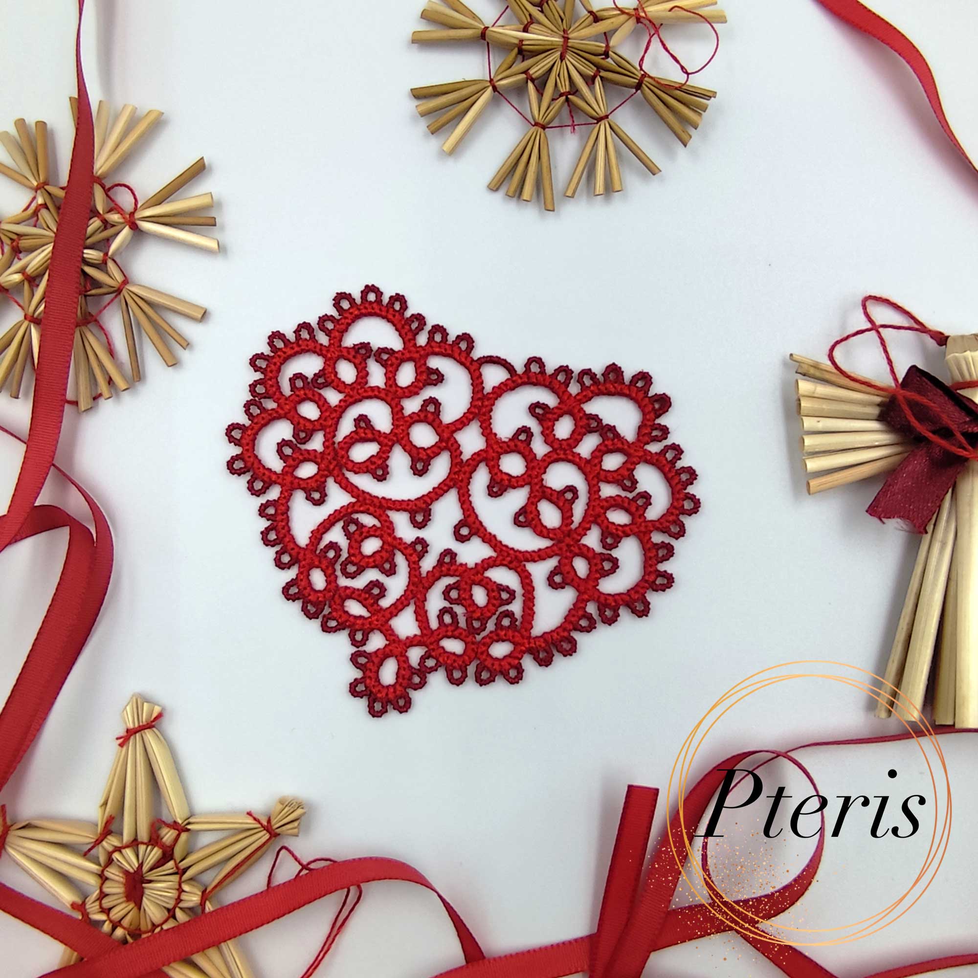 FSL Tatting Heart Pendant Design featuring a bright red freestanding lace heart ornament suspended by a ribbon, surrounded by festive evergreen branches and straw stars.