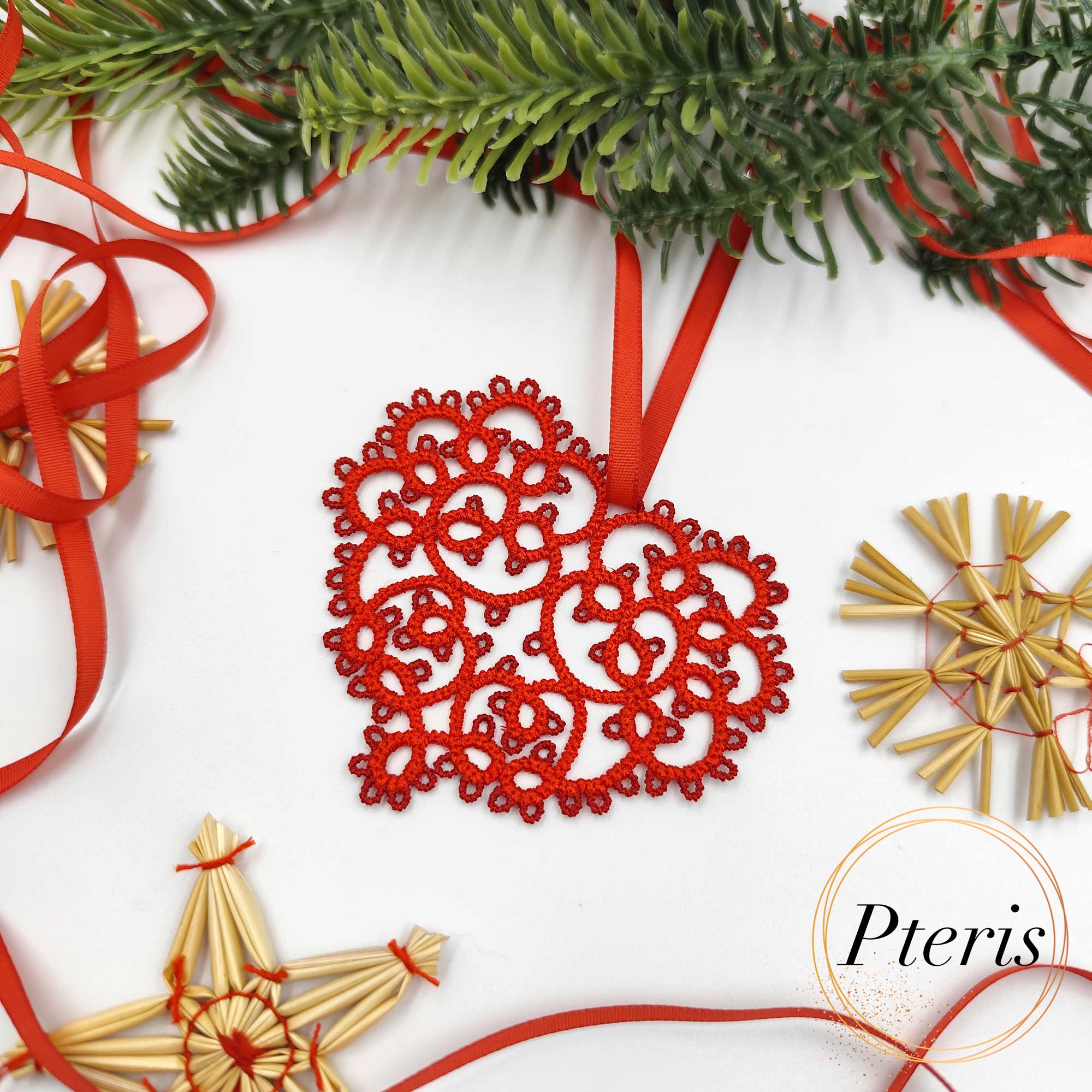 FSL Tatting Heart Pendant Design featuring a bright red freestanding lace heart ornament suspended by a ribbon, surrounded by festive evergreen branches and straw stars.