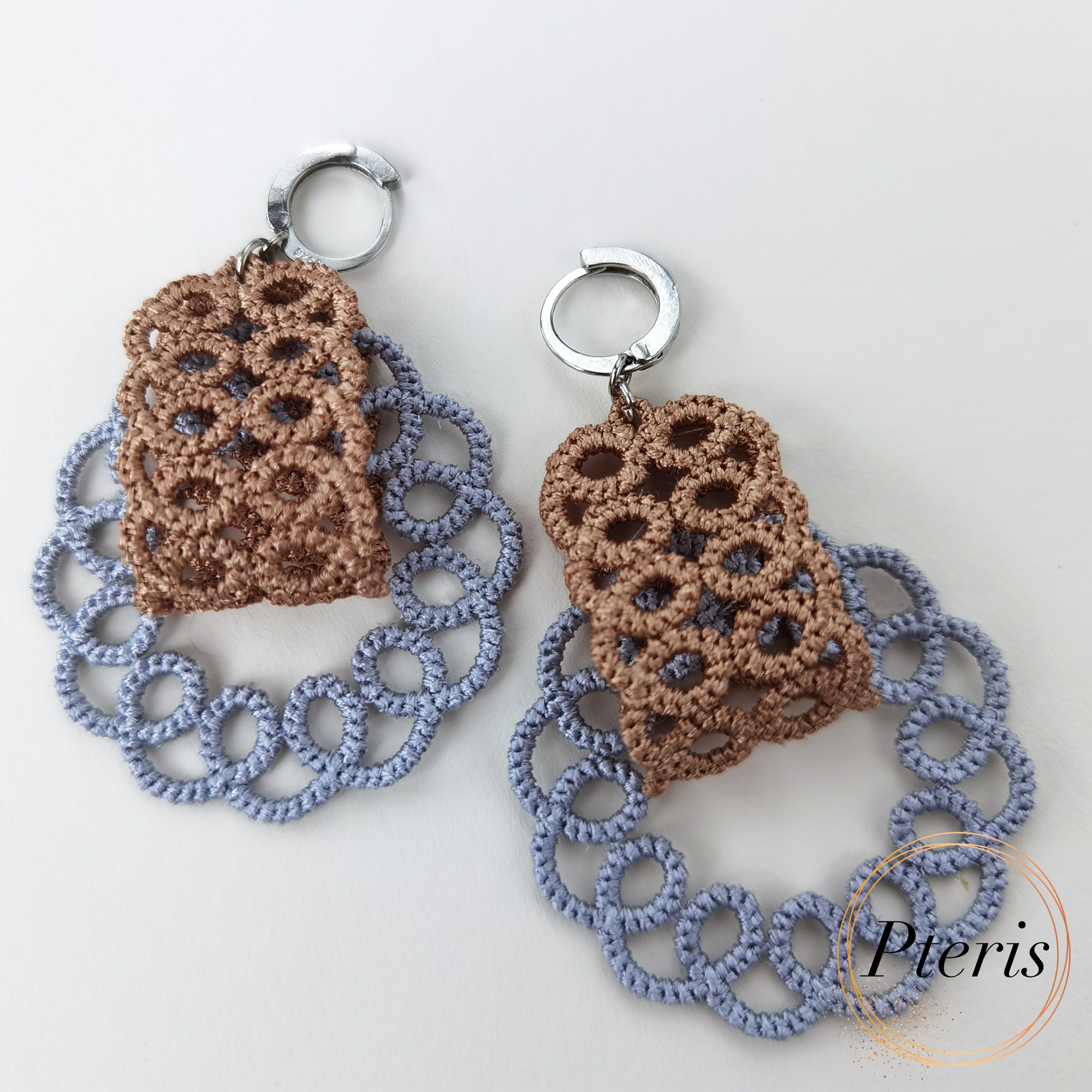 FSL Tatting Earrings Embroidery Design showing a pair of intricate freestanding lace earrings with brown top elements and blue-grey looped lace bottoms.