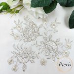 Elegant Flowers Machine Embroidery Design showing an intricate, monochrome vintage floral bouquet motif stitched beautifully in soft champagne thread on a crisp white fabric canvas.