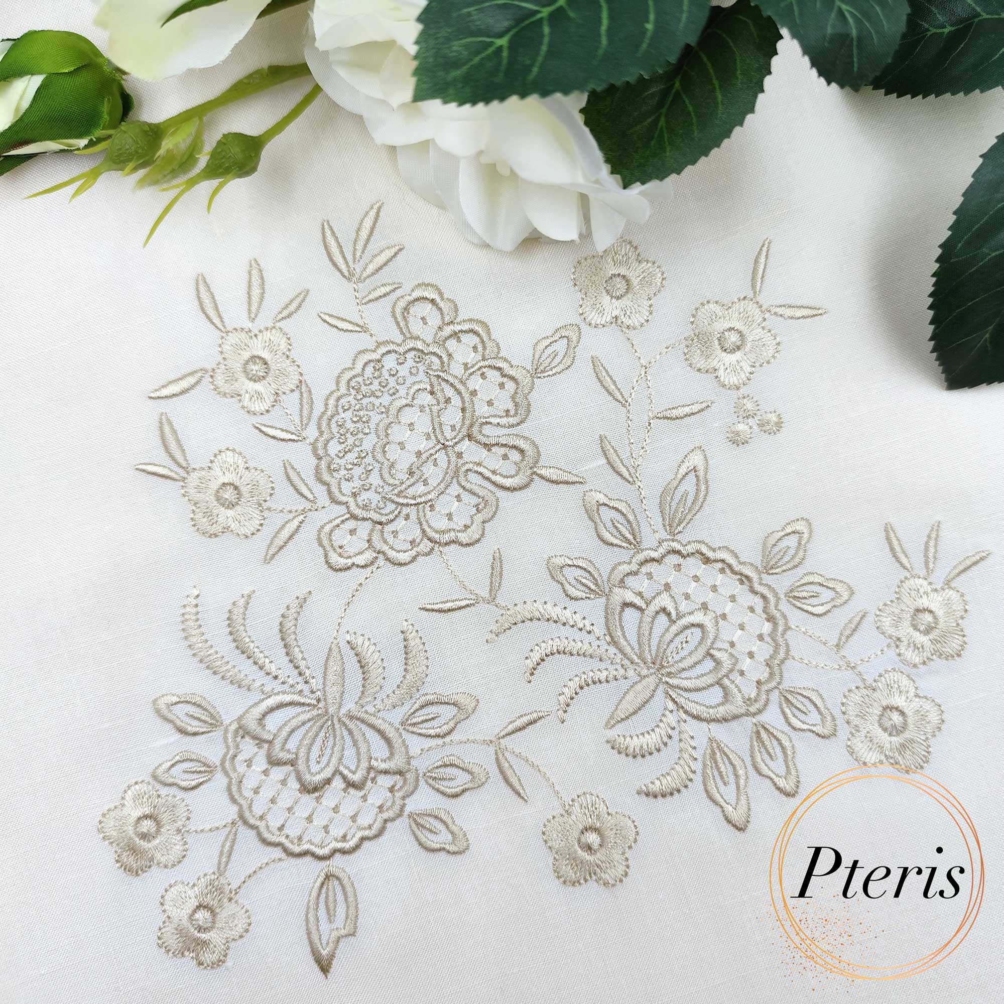 Elegant Flowers Machine Embroidery Design showing an intricate, monochrome vintage floral bouquet motif stitched beautifully in soft champagne thread on a crisp white fabric canvas.