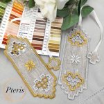 Hardanger bookmark machine embroidery design featuring an intricate freestanding lace bookmark with elegant geometric cutwork windows, styled flat on the pages of an open vintage book.