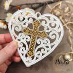 Mini FSL Heart with Cross machine embroidery design showing a completed freestanding lace heart-shaped ornament held by hand, featuring intricate white lace scrollwork surrounding an embroidered gold cross in the center.
