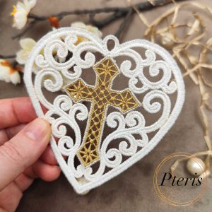 Mini FSL Heart with Cross machine embroidery design showing a completed freestanding lace heart-shaped ornament held by hand, featuring intricate white lace scrollwork surrounding an embroidered gold cross in the center.